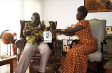 Akua presents a copy of her book to ex-President Kuffour at his residence