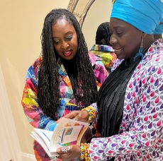 Akua share her book with Dawn Butler